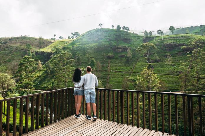 Couple in love at tea plantation. Travel to Sri Lanka. Green tea plantations in the mountains