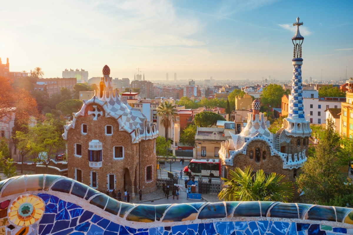 Barcelona city view from Guell Park. Sunrise view of colorful mosaic building in Park Guell