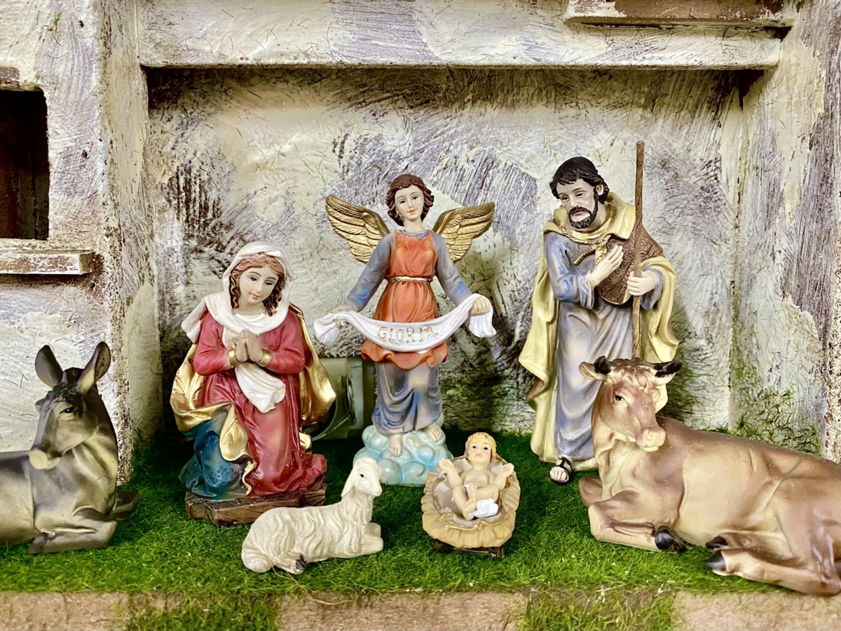 Beautiful nativity scene with an Angel holding a sign that says Gloria.