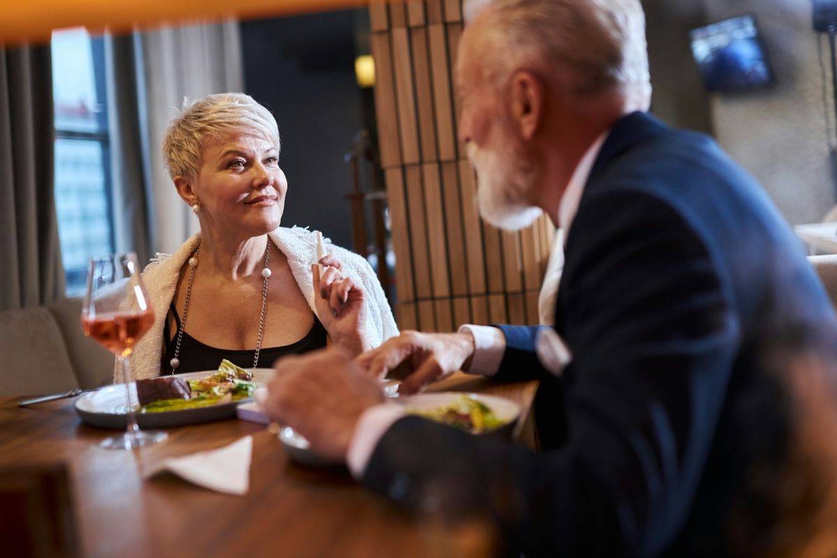 Mature couple fine dining food in hotel or elegant expensive restaurant