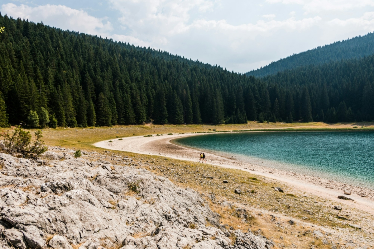 Walk along the mountain lake. Black Lake in Durmitor National Park. Montenegro