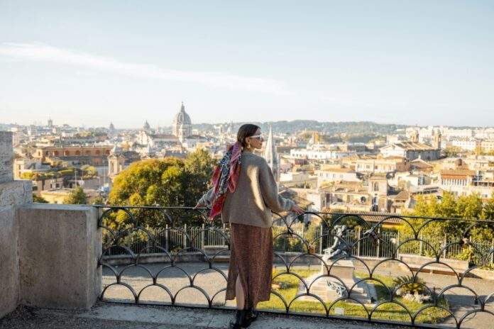 Woman enjoying beautiful morning cityscape of Rome