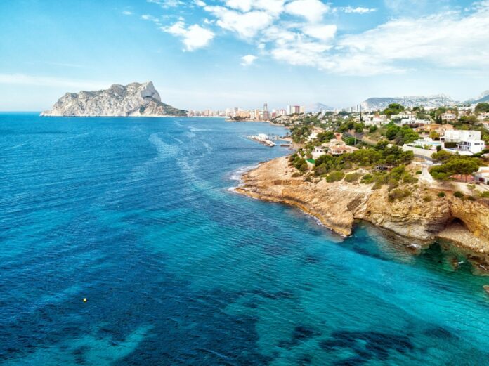 Aerial shot of the Mediterranean sea washing the Benissa rocky coastline, Costa Blanca, Spain