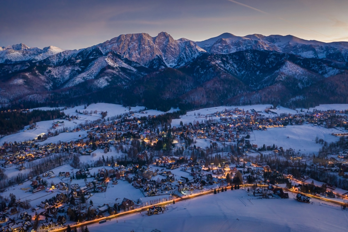 Illuminated Zakopane city in winter after dusk, aerial view