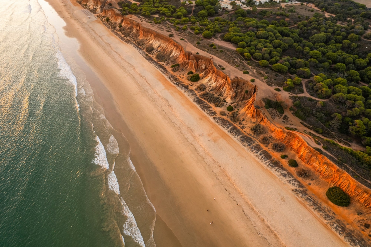 Praia da Falesia, Algarve beach in Albufeira, Portugal. Aerial drone view at sunset