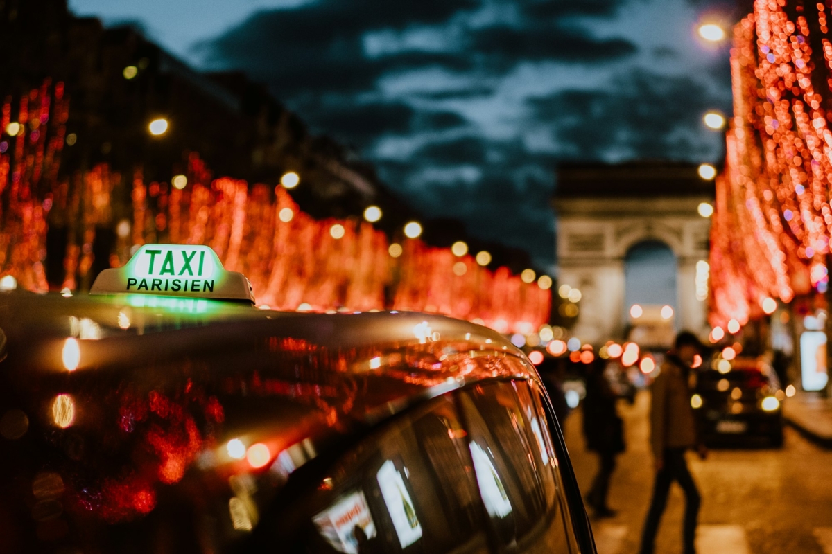 Taxi in the night Paris light christmas people walking on the street