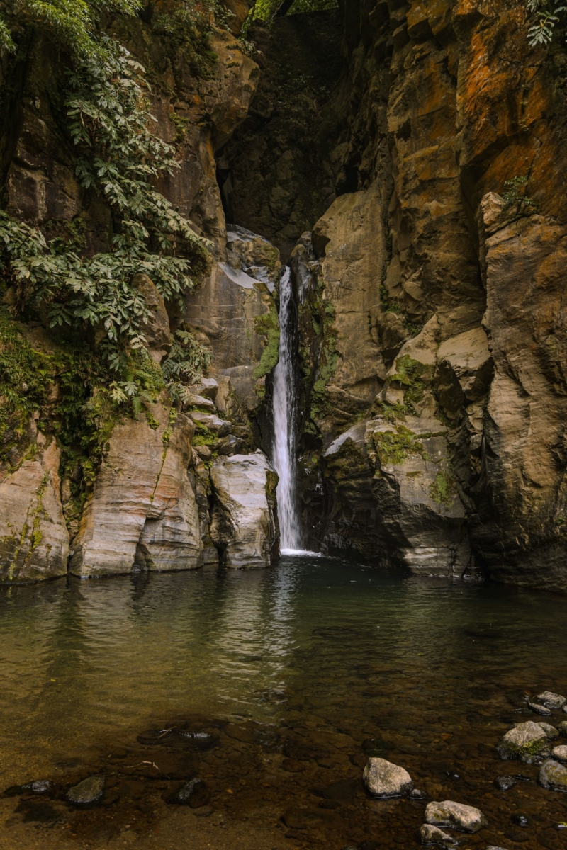 Vertical shot of the beautiful Salto do Cabrito Waterfall in Azores