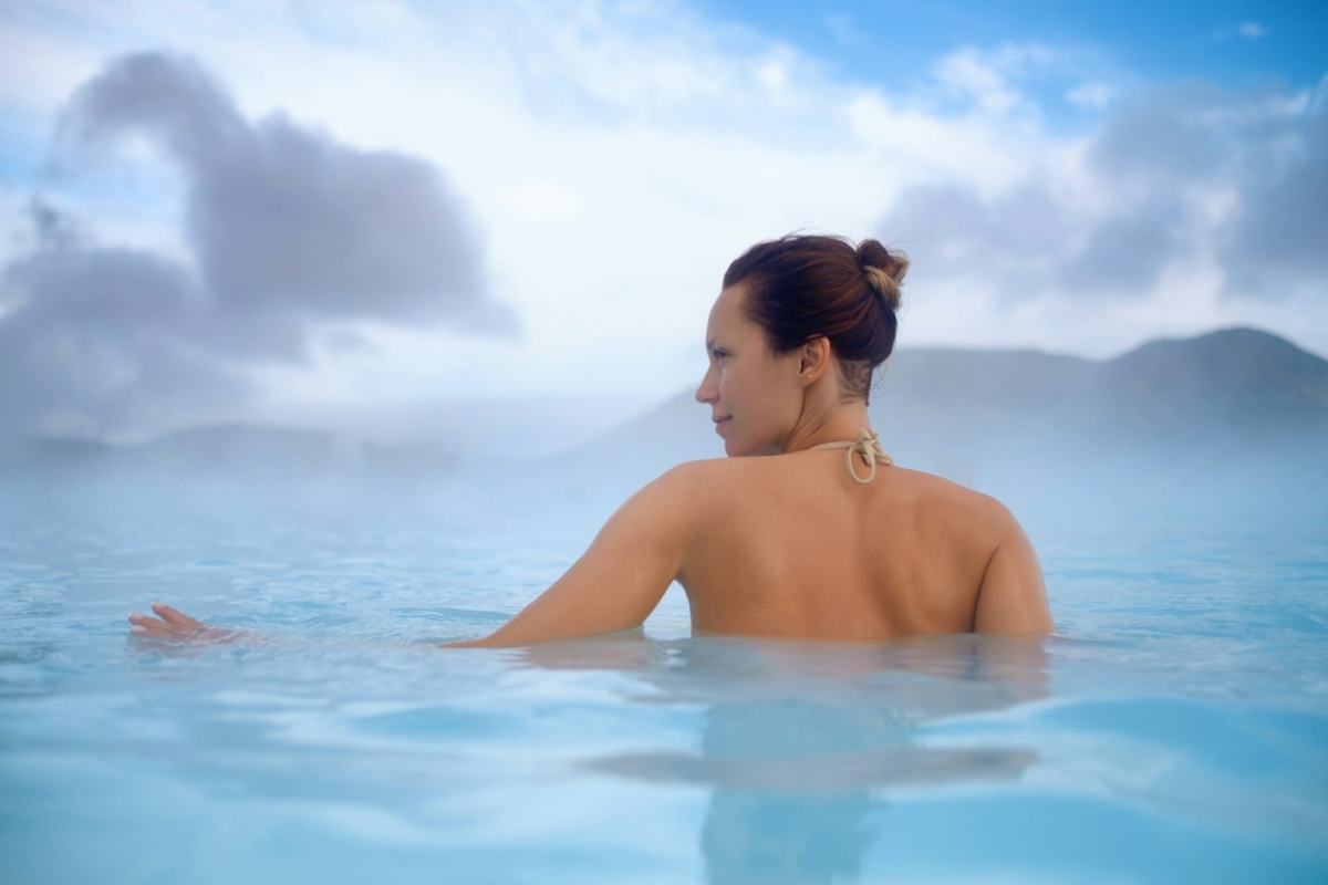 Woman enjoys spa in geothermal hot spring